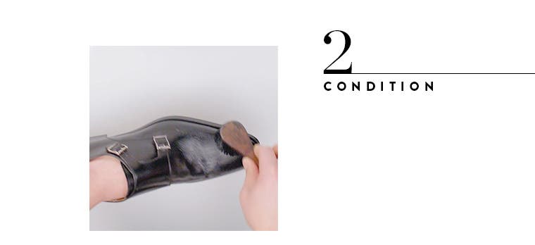 Conditioning leather shoes.