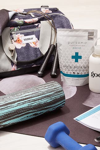 goop fitness products on a yoga mat.