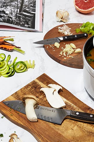 Cut vegetables, fruit and mushrooms on cutting boards..