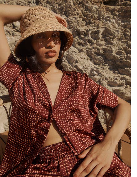 A model wearing a sun hat and a matching set.
