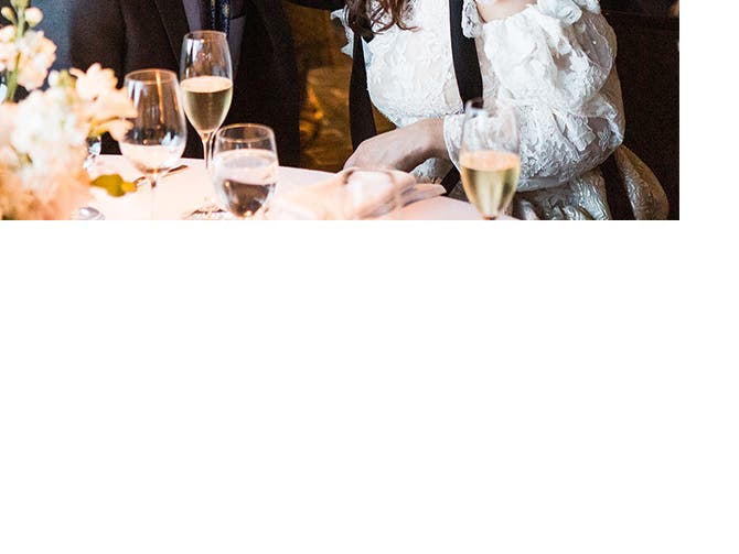The bride and groom share a special moment at their table during the reception.