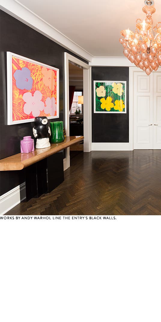 Andy Warhol artwork lines the walls of a black-and-white foyer.