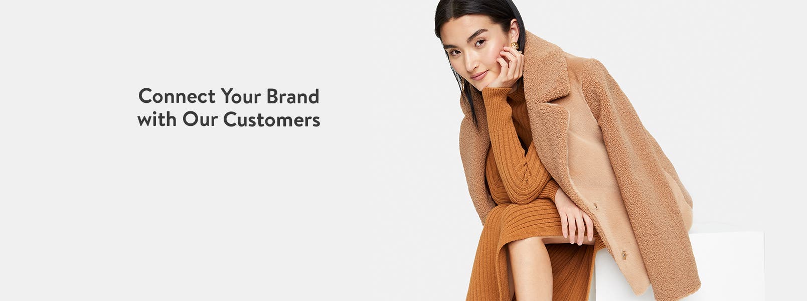 Connect Your Brand with Our Customers. A woman in fuzzy coat and sweaterdress.