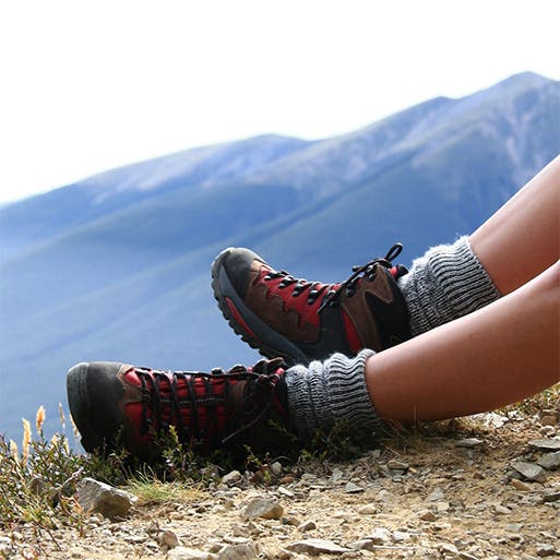 A close-up view of a person wearing hiking boots.