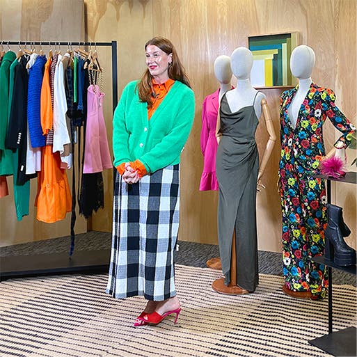 Kate Bellman surrounded by fall-season styles.