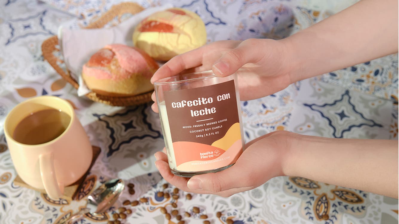 A person holds a Bonita Fierce candle.