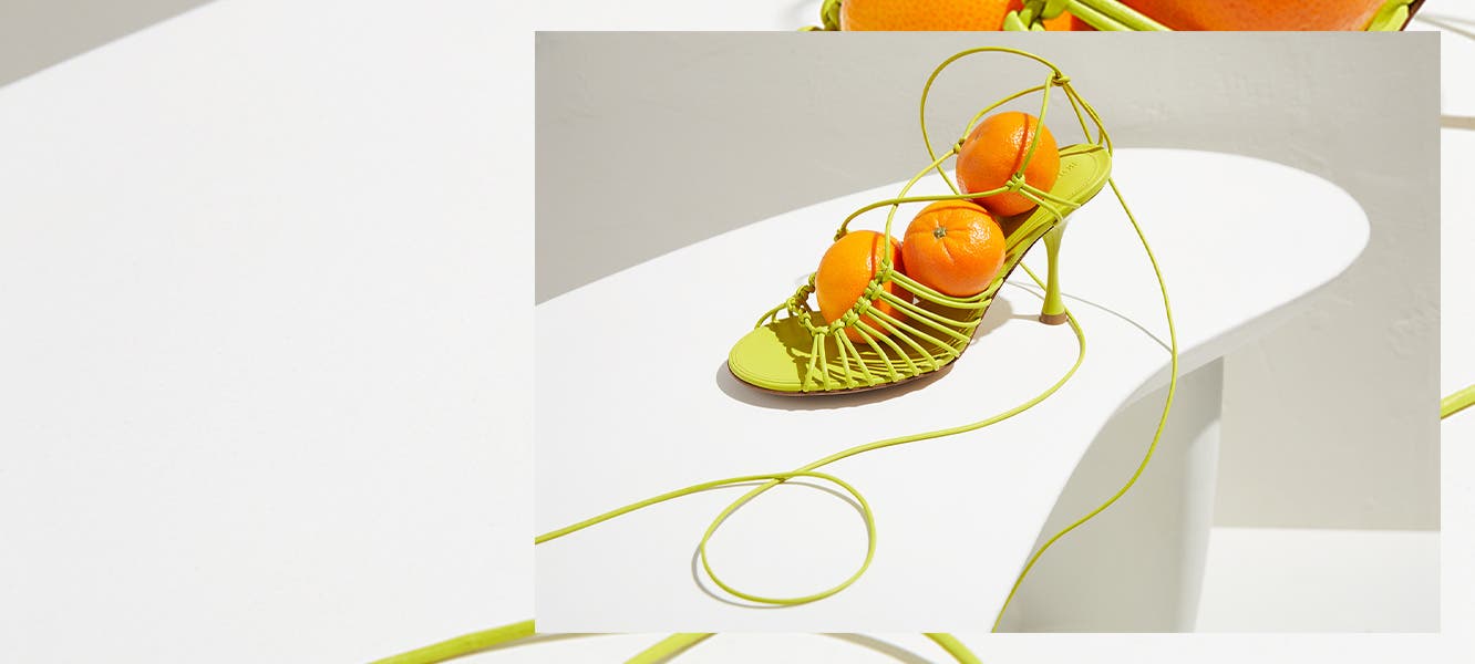 Green Balenciaga handbag, orange Bottega Veneta shoe, green Miu Miu loafers, yellow Bottega Veneta heels, Loewe handbag.