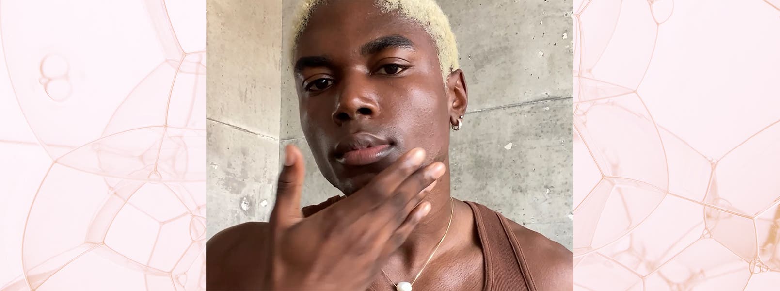 A man applies skin care to his face.