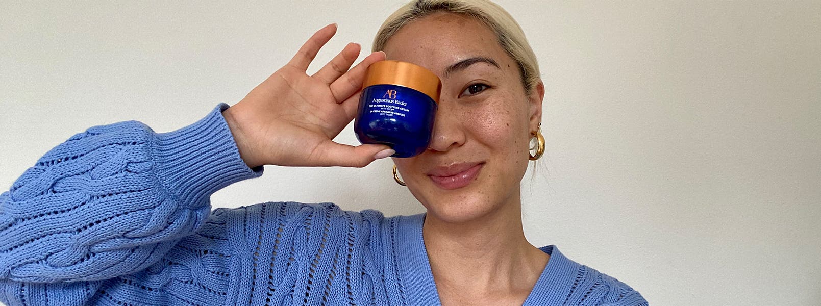 Woman holding a skin care product.