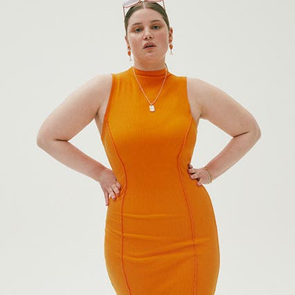 A woman wearing a form-fitting orange dress.