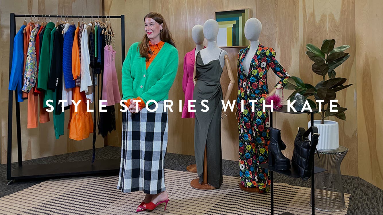 Kate Bellman surrounded by fall-season styles.
