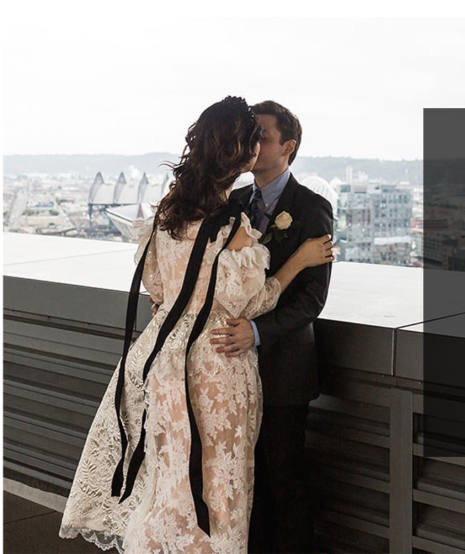 The bride and groom share a kiss on the courthouse balcony after saying "I do."