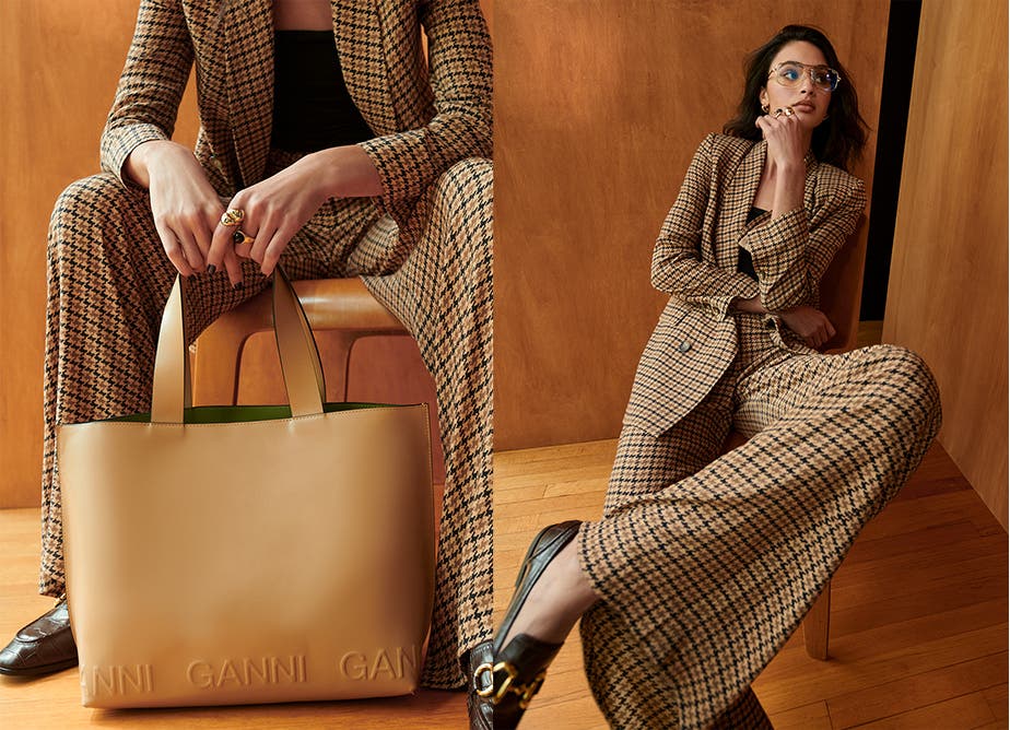 A woman in a houndstooth-check suit and glasses.