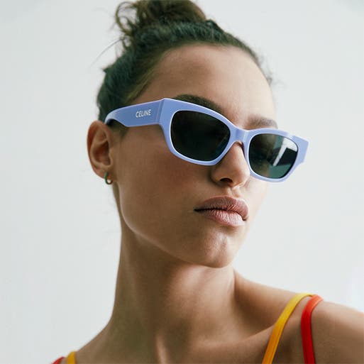 A model wearing blue sunglasses.