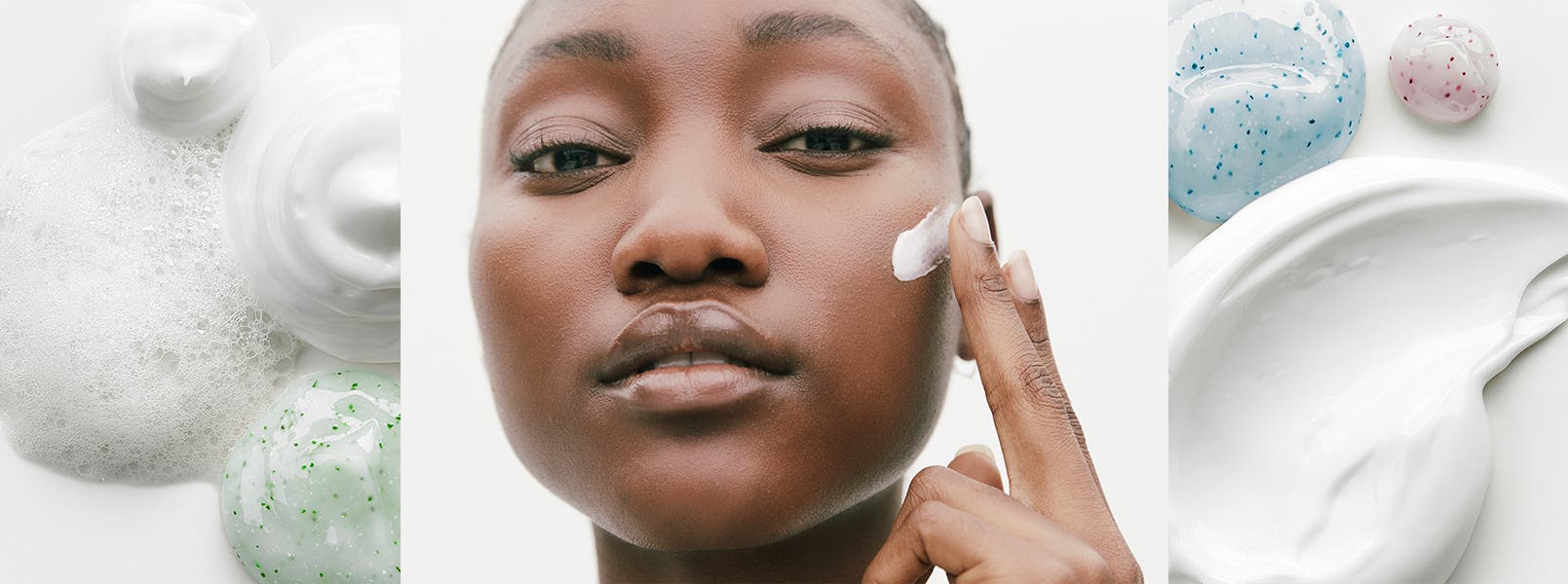 A woman applies a skin care product to her face.