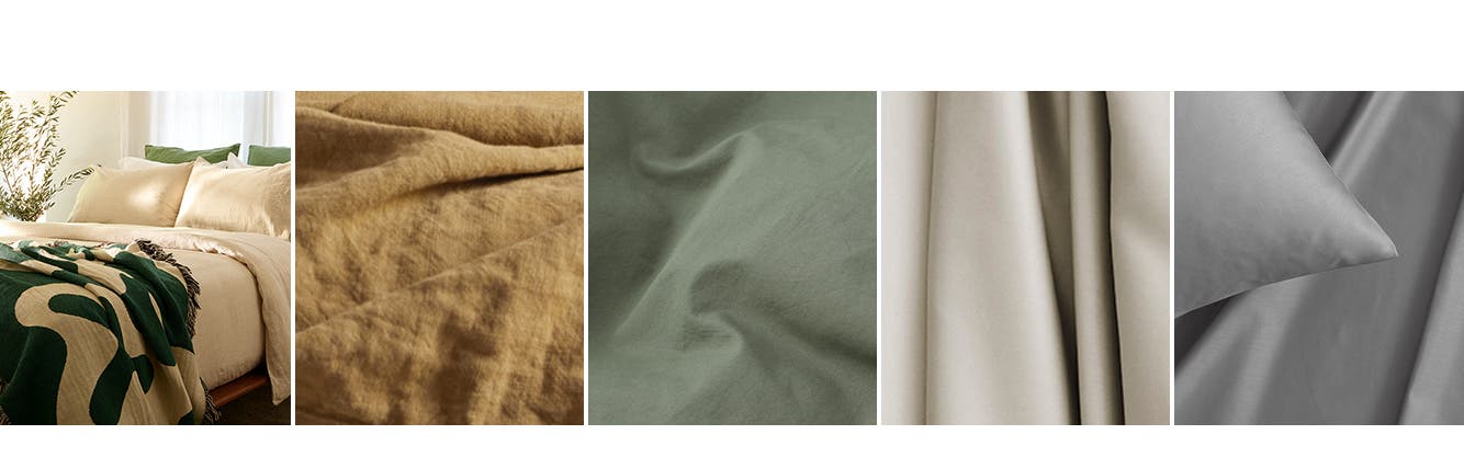 A bed made with cream, white and green bed linens. An ochre-colored linen sheet. A sage green percale sheet. An ecru cotton sheet. A grey sateen pillowcase and sheet.