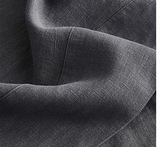 A closeup of dark grey linen sheets.