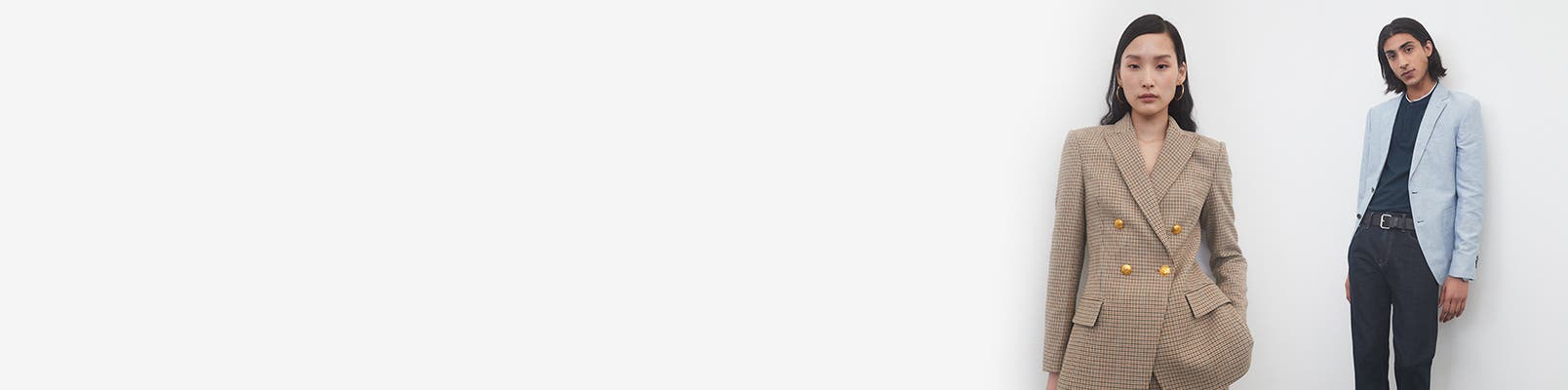 A woman in a brown suit; a man in a sport coat and slacks.