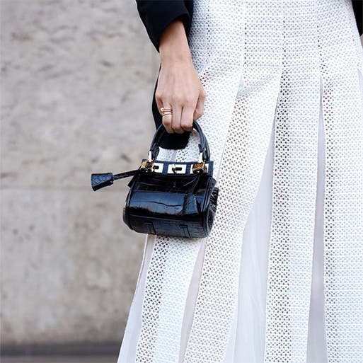 A woman wearing a white midi skirt.