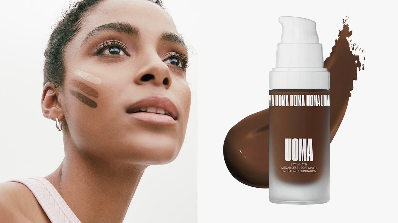 A woman model with three different shades of foundation striped on her cheek; a bottle of UOMA BEAUTY Say What?! Weightless Soft Matte Foundation with a swatch of the product splashed behind it.