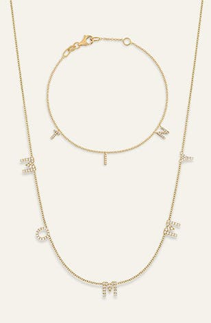 A gold bracelet and necklace decorated with diamond letter charms.