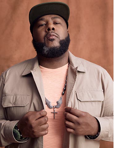 Jeremy Johnson models T-shirt, button-up and necklace.