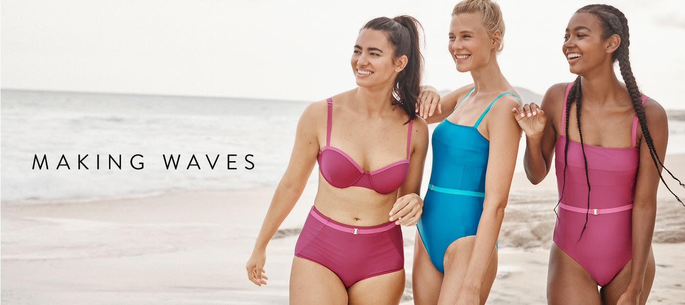 Three women at the beach wearing Summersalt swimsuits.