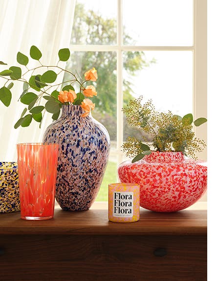 Colorful glass vases, bowl and candle.
