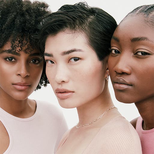 Three women with different skin tones.