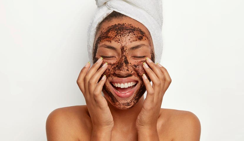 woman smiling with skin care mask on