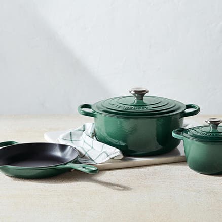 Green Le Creuset pots and pans.