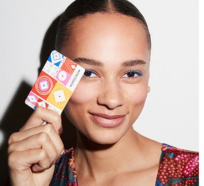 Close-up of a woman holding a Nordstrom Gift Card.