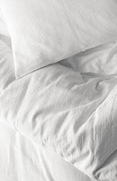 A white cotton duvet cover and pillow.
