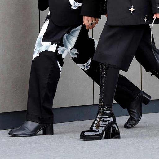 Two women wearing black boots.