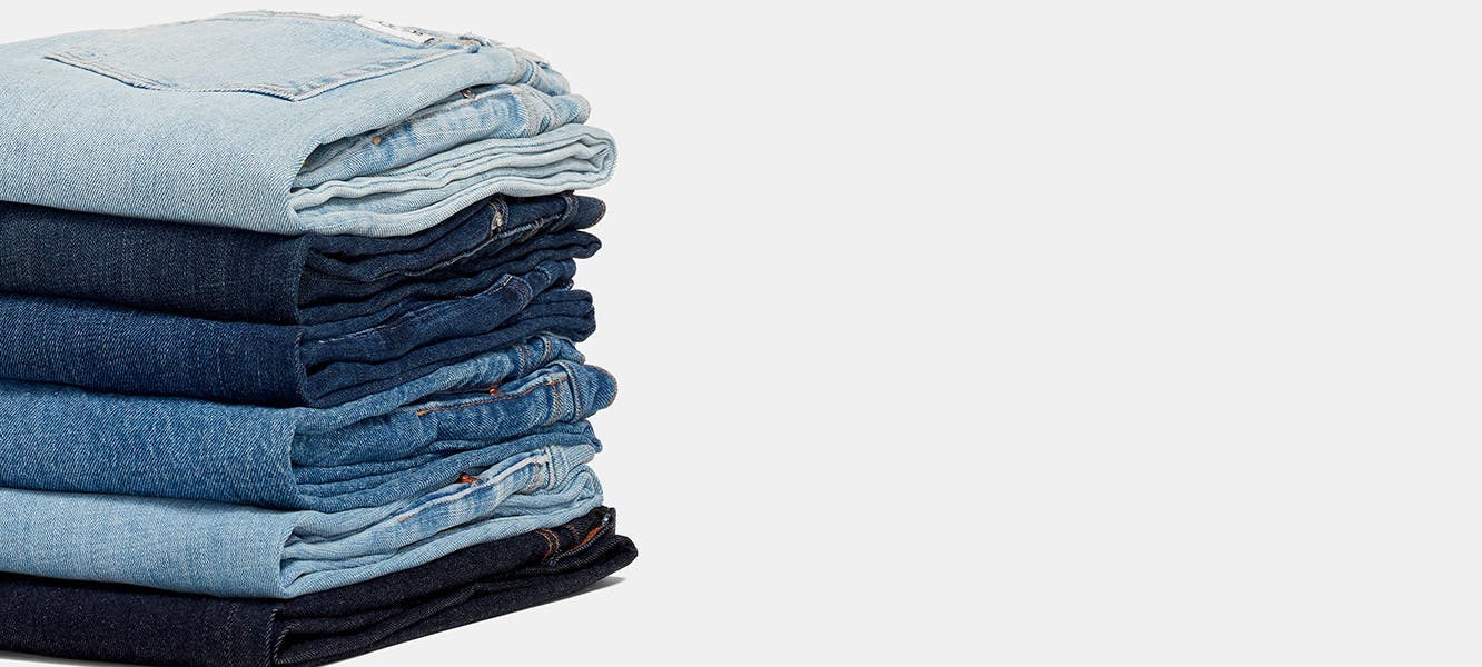 A stack of folded jeans in various washes.