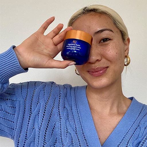 Woman holding a skin care product.
