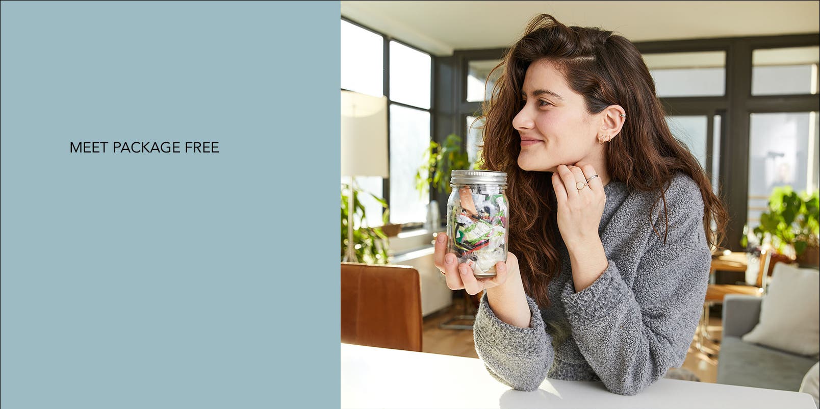 Lauren Singer holding her Mason jar full of trash.