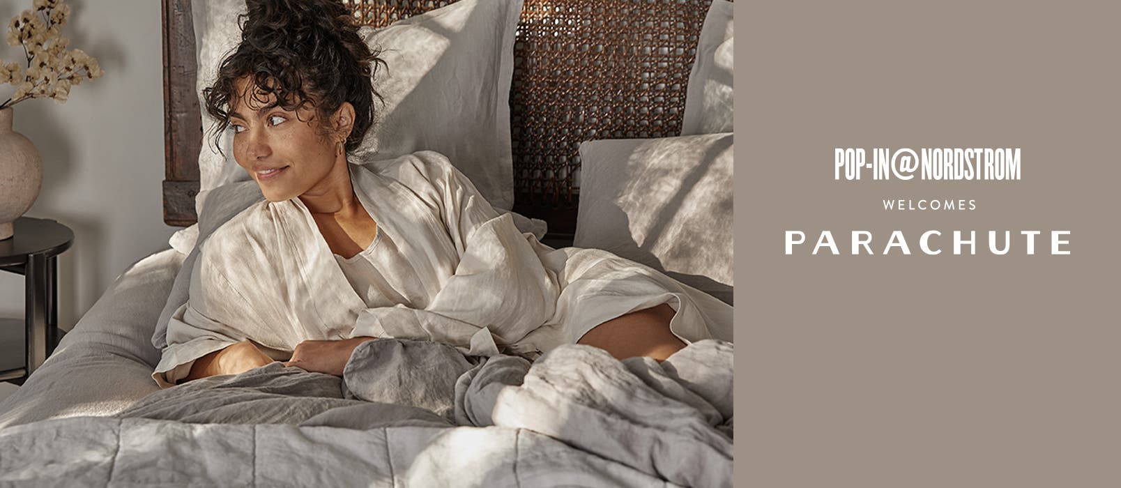 Pop-In@Nordstrom Welcomes Parachute: a woman on a bed made with Parachute bedding.