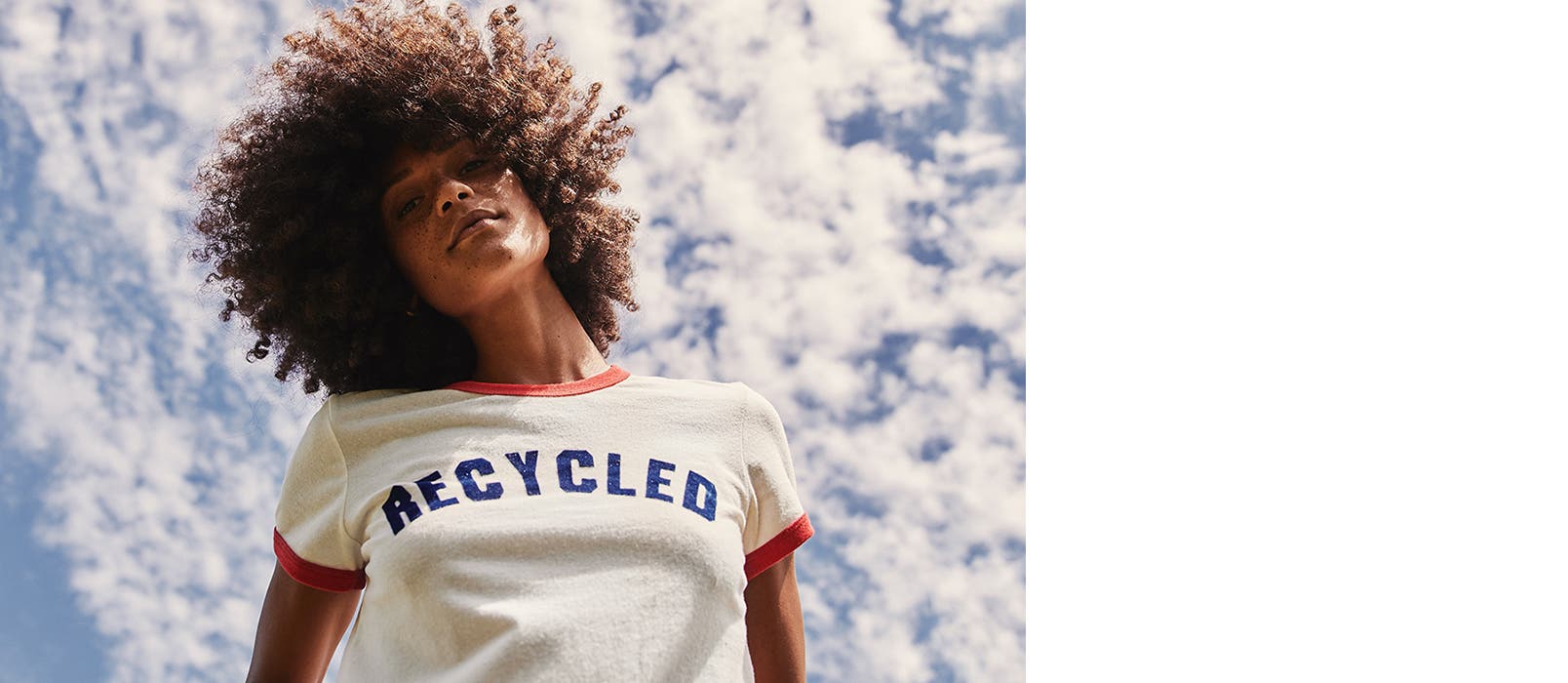 Model wearing a Marine Layer T-shirt printed with the word "Recycled."
