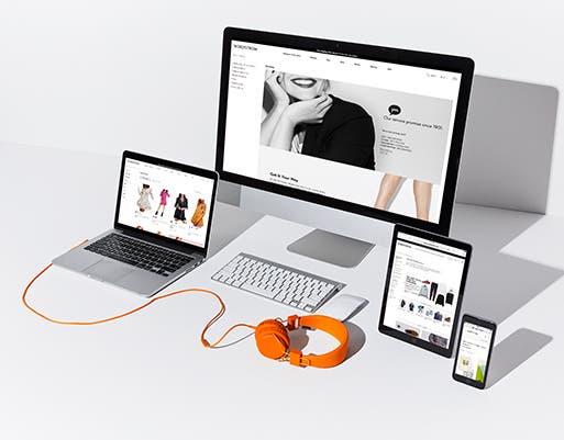 A laptop, desktop monitor, tablet and phone showing Nordstrom.com.