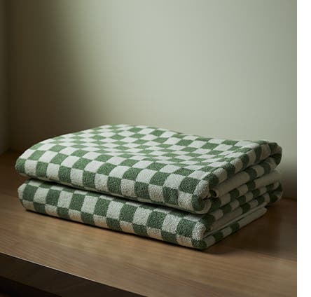 Two green checkerboard print towels.
