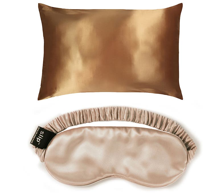 A gold silk Slip pillowcase and caramel-colored silk Slip sleep mask.