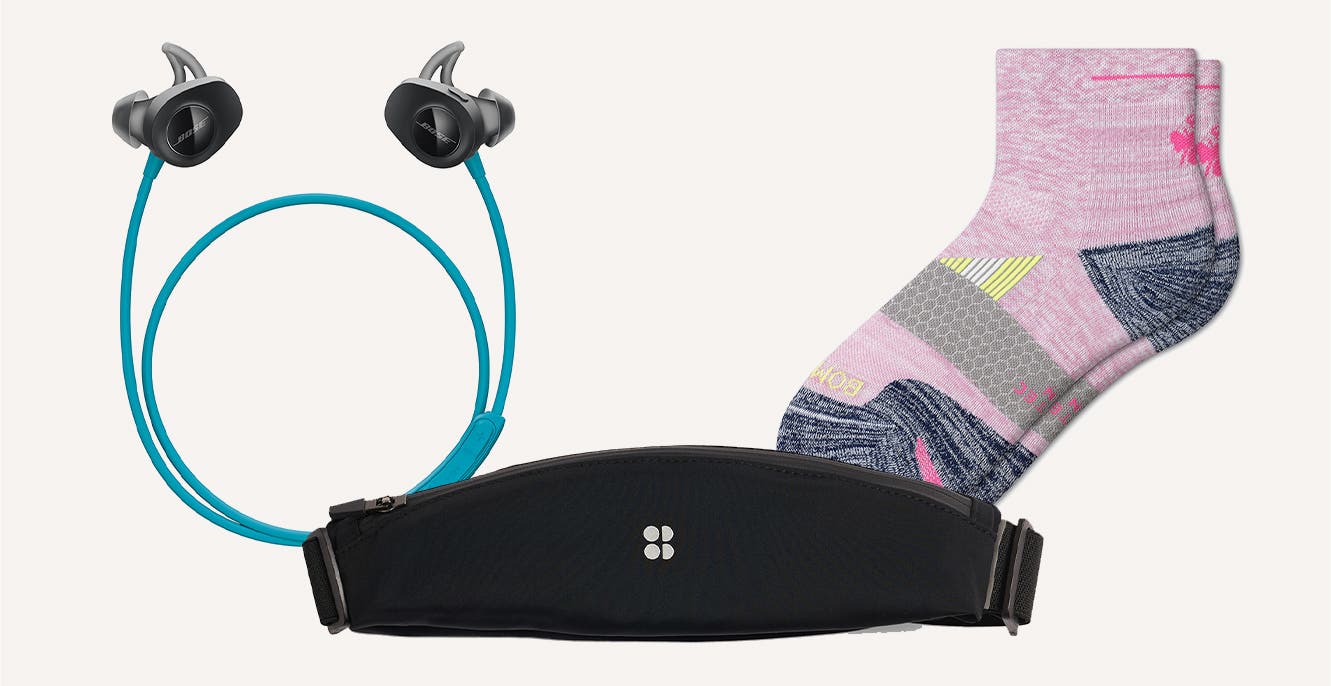 Blue Bose wireless headphones; a black Sweaty Betty running belt; pink multicolored Bombas socks.
