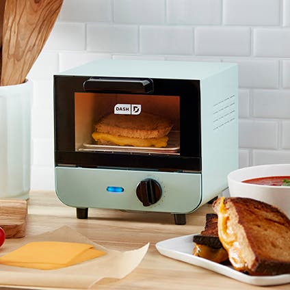 An aqua-colored mini toaster oven.
