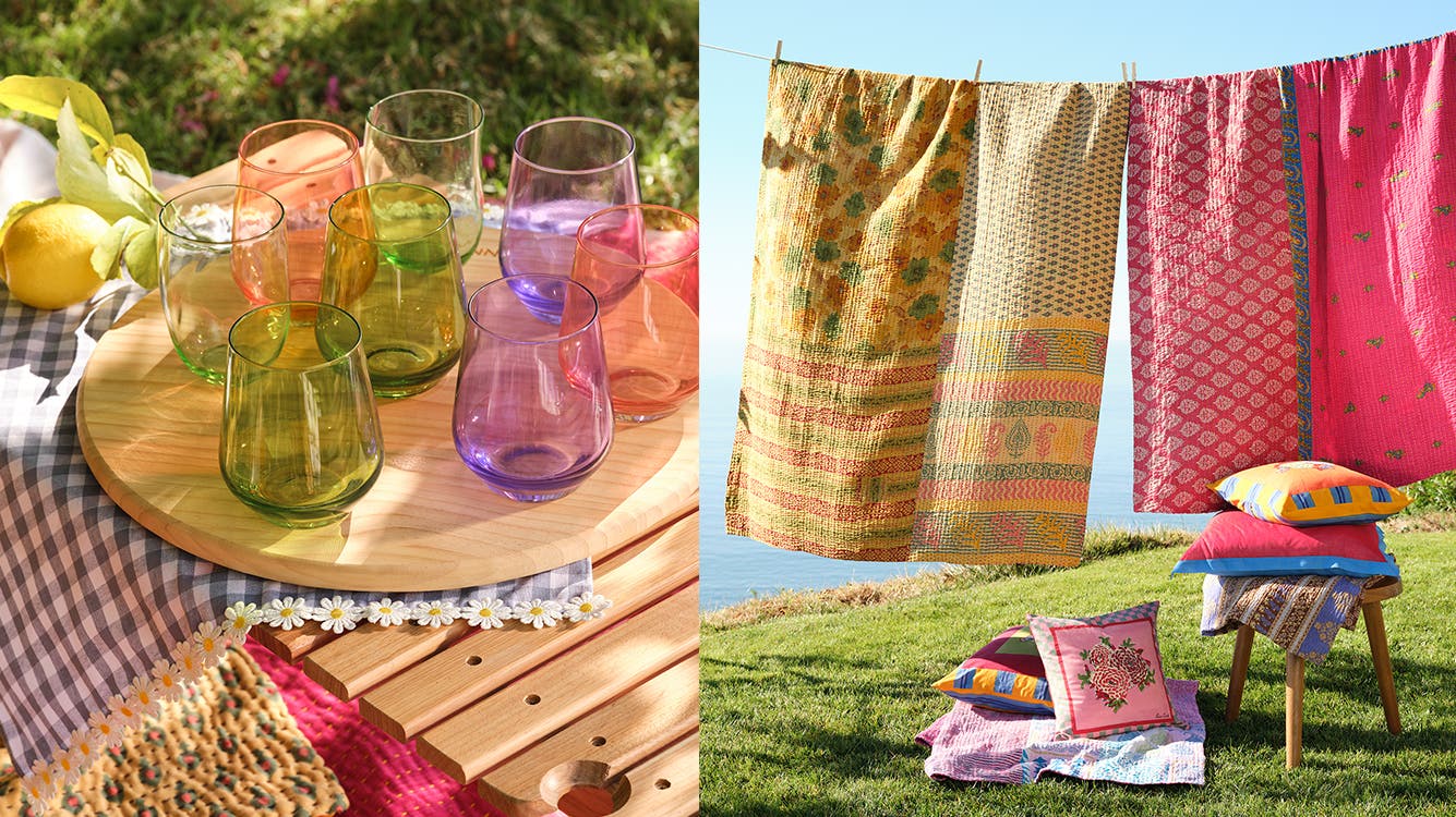 A close-up of colorful glasses placed on a picnic basket; brightly colored sheets hanging from a clothesline with a stack of bright pillows placed nearby.