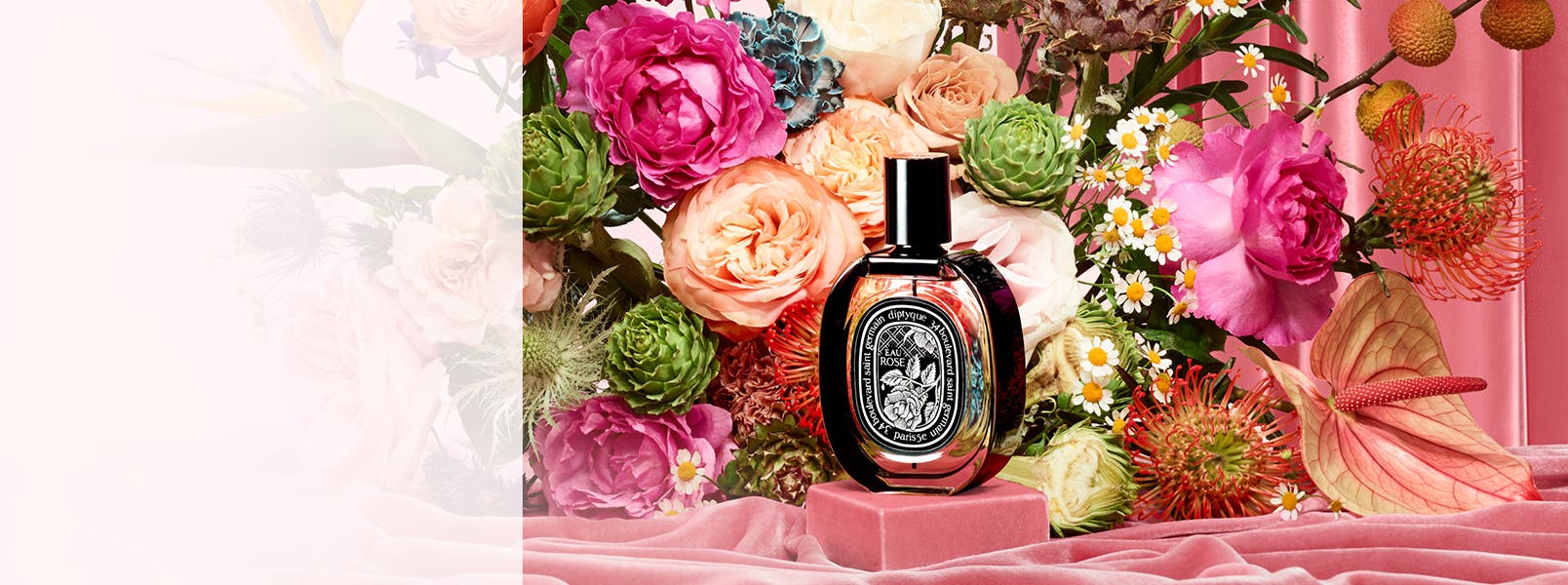 diptyque's new Eau Rose collection of fragrance and candles amid an exuberant floral display.