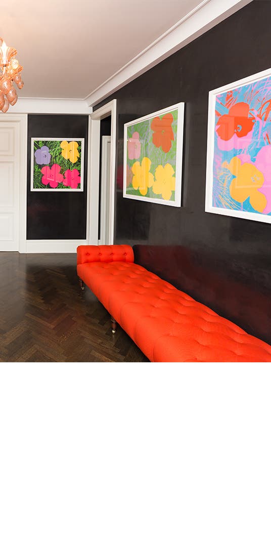Andy Warhol artwork lines the walls of a black-and-white foyer.