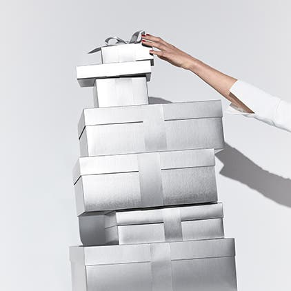A stack of Nordstrom silver gift boxes.