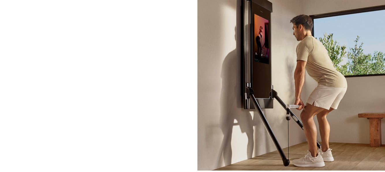 A man exercises at home with Tonal.