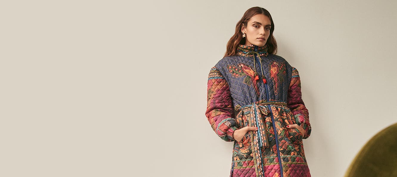 A woman wearing a printed quilted coat.
